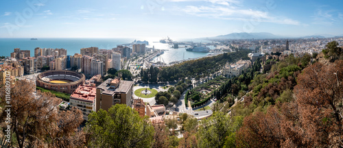 Panorama cityscape aerial view of Malaga, Spain. In the center is Plaza de Toros de Ronda bullring in Malaga, Spain.