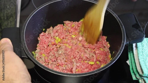 Cooking ground beef with vegetables in a kitchen at home for a delicious meal