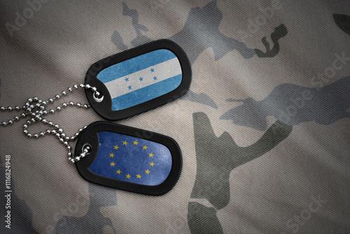 army blank, dog tag with national flag of honduras and european union on the khaki texture background. military concept. photo