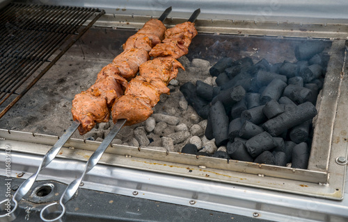 Juicy skewers being grilled on a charcoal barbecue, illustrating outdoor cooking, delicious flavors, and smoky aromas. Perfect for summer barbecues, parties, and culinary inspiration