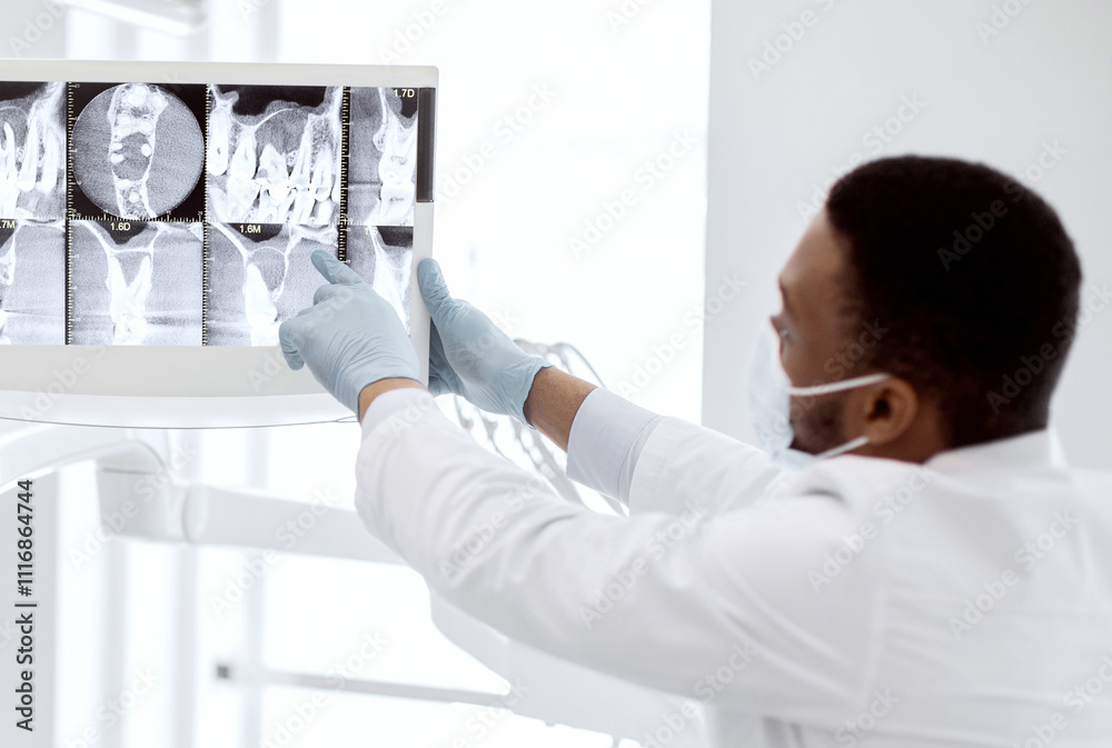Black Stomatologist Showing Treatment Result At Teeth Xray Picture To Female Patient, Professional Dentist Doctor Pointing At Digital Monitor During Check Up In Modern Stomatological Clinic, Closeup Black Stomatologist Showing Treatment Result At Teeth Xray Picture To Female Patient, Professional Dentist Doctor Pointing At Digital Monitor During Check Up In Modern Stomatological Clinic, Closeup