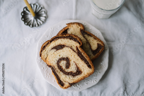 Close-up of swirl bread slices on white plate and cloth photo