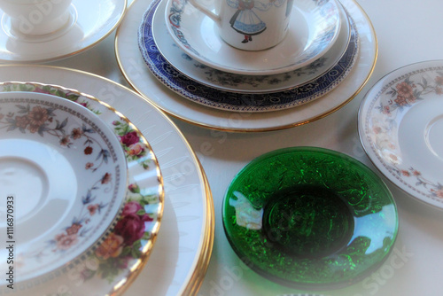 Fotografie close-up of random mismatched porcelein china plates saucers dishes decluttering