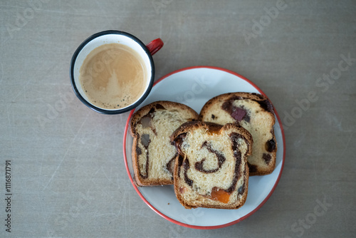 Chocolate bread and coffee on table, top-down view. photo