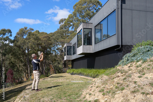 Building Inspector checking exterior of modern home photo