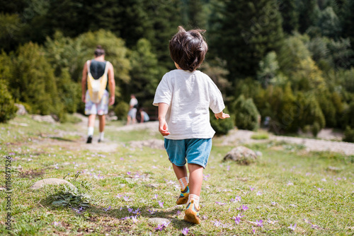 Confident toddler following father at the mountain