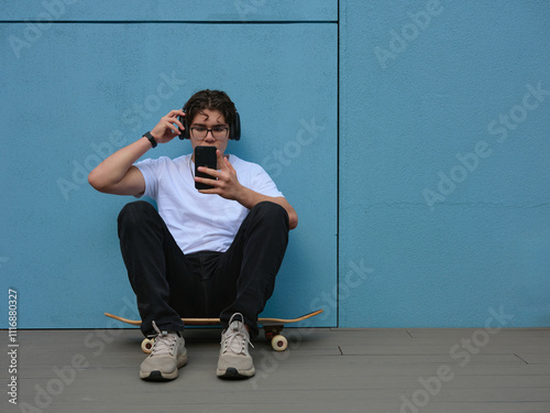 Young person listening to music through headphones photo