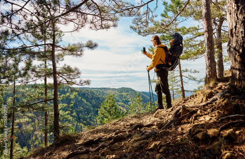 Man takes photos from a mountain viewpoint
