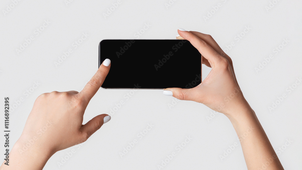 Closeup view of woman touching mobile phone with blank screen on light background, copy space Closeup view of woman touching mobile phone with blank screen on light background, copy space