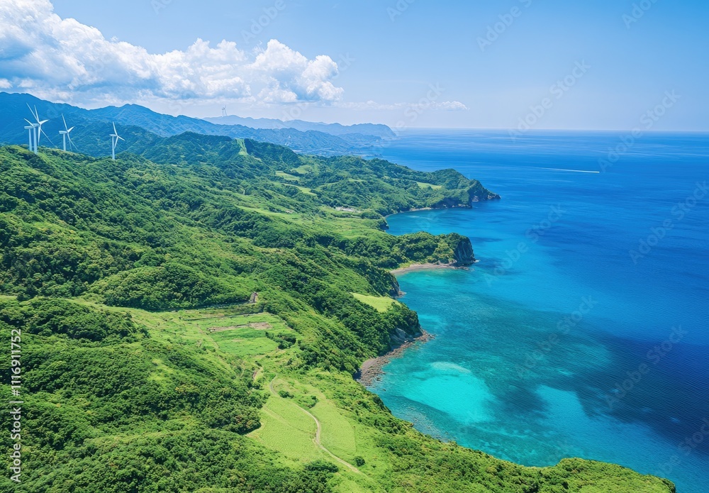 Obraz premium Coastal Landscape Featuring Wind Turbines and Lush Green Hills