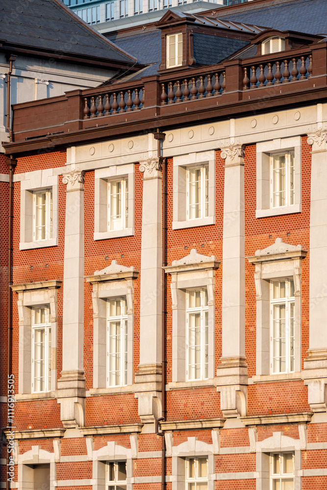 Obraz premium The facade of Tokyo Station with beautiful large windows in Chiyoda City during sunset with warm colours at daytime outdoor in Japan.