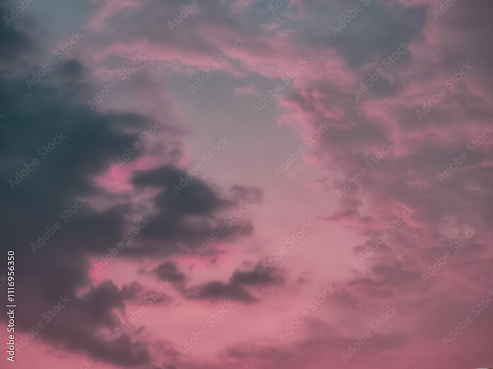 A moody, dramatic sky with dark clouds and a soft pink hue. Perfect for backgrounds or to evoke a sense of mystery and emotion A moody, dramatic sky with dark clouds and a soft pink hue. Perfect for backgrounds or to evoke a sense of mystery and emotion