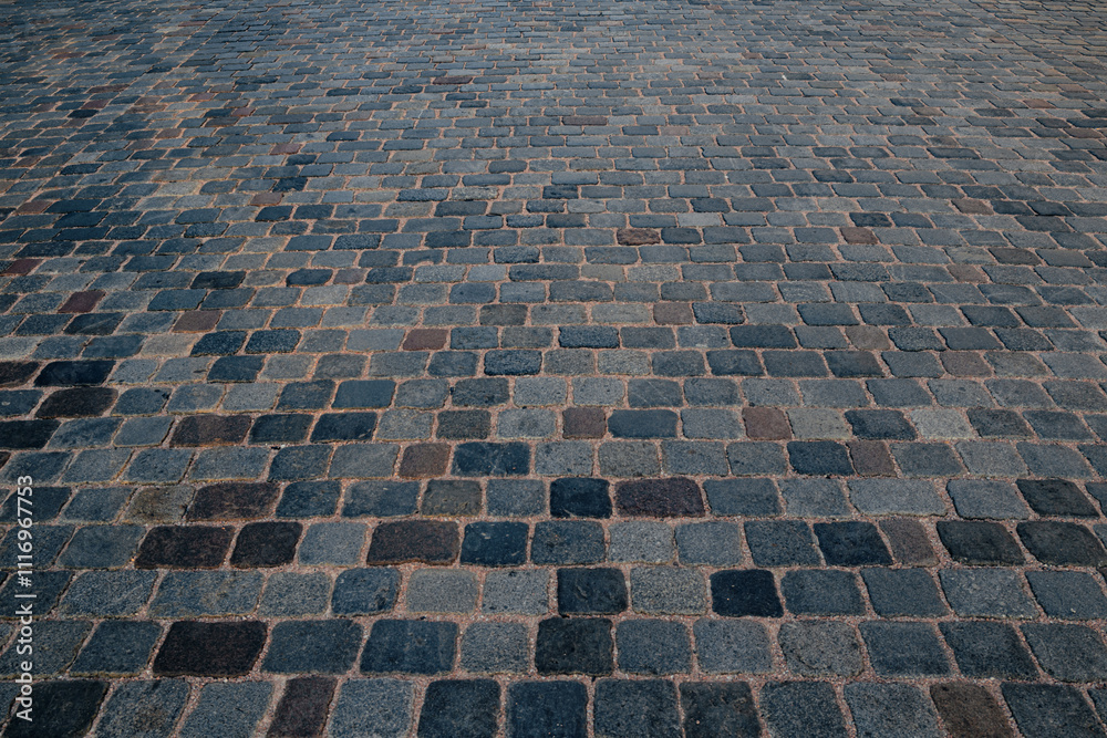 Fototapeta premium Pavement road. Stone cladding. Rough brick road. Cobblestone pavement background. Textured background. Sidewalk. Road. Old cobblestone road.