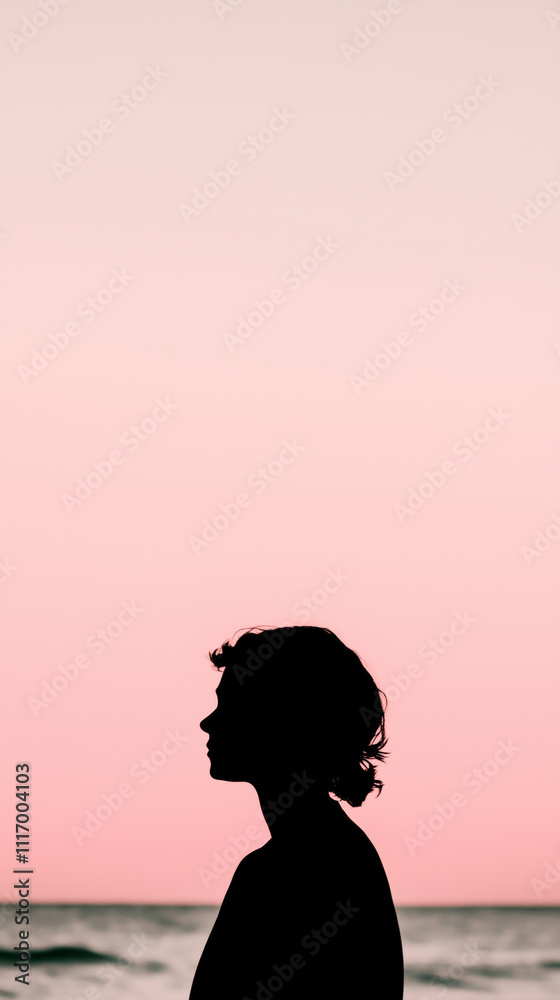 Phone wallpaper of the silhouette of a woman with short hair gazing at the ocean under a serene pink-hued sky Phone wallpaper of the silhouette of a woman with short hair gazing at the ocean under a serene pink-hued sky
