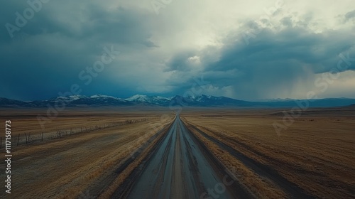 Dramatic clouds over a long, wet road stretching towards distant mountains.