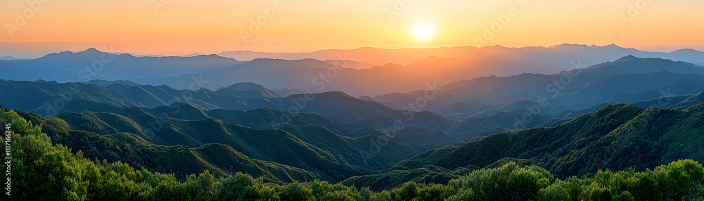 Fototapeta premium Sunset over rolling green mountains.