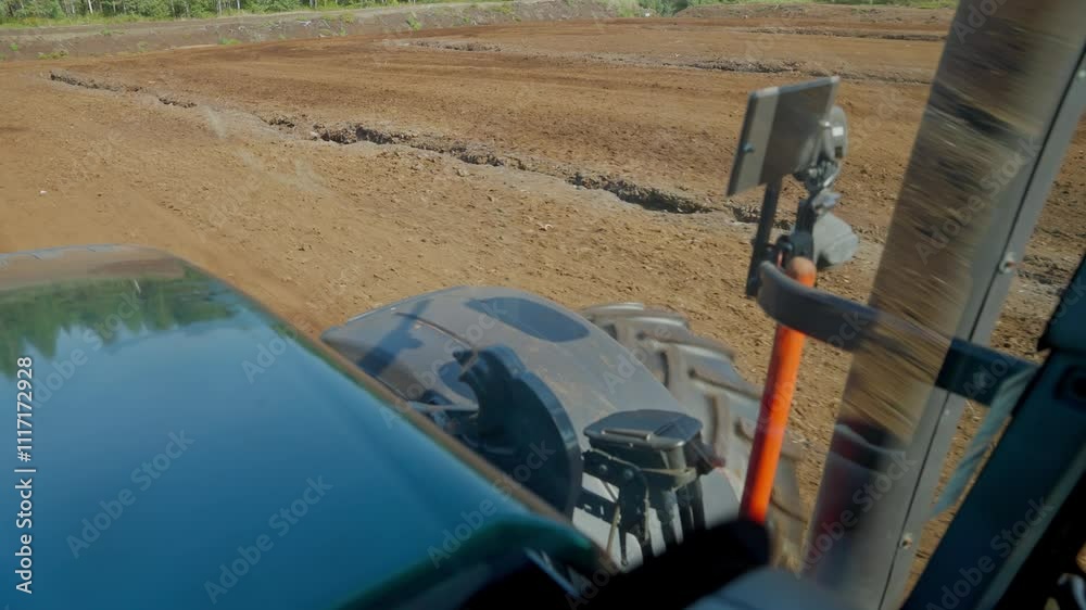 Cab operator POV driving inside tractor machinery in a peat harvesting field Cab operator POV driving inside tractor machinery in a peat harvesting field