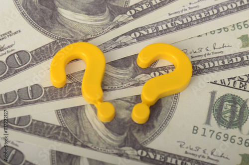 Understanding Financial Uncertainty: Question Mark and USD Money Background Symbolizing Economic Decisions photo