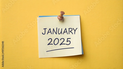 January 2025 and wooden push pin on yellow background. photo