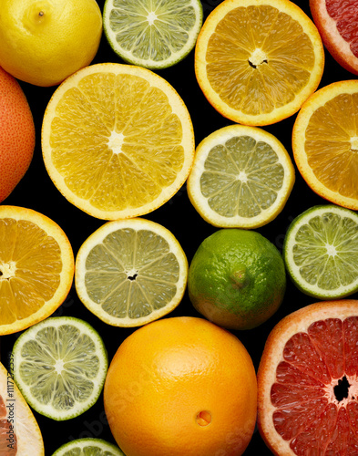 Assorted Citrus Fruits on Black Background photo