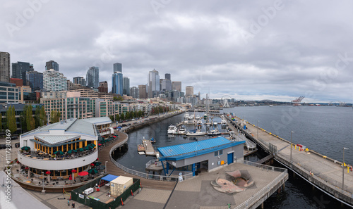 Panoramic view of the Seattle Waterfront along the Puget Sound with downtown district skyscrapers, the Pike Place Market district, and Great Wheel in view.