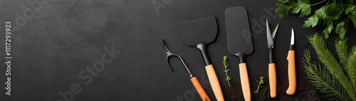 A gardening toolkit with hand trowels and pruning shears, arranged neatly on a bed of fresh soil photo