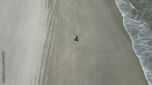 Person is walkin on a sandy beach