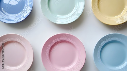 of colorful ceramic plates arranged neatly, isolated on white, with a focus on their smooth texture. Ceramic appliances 