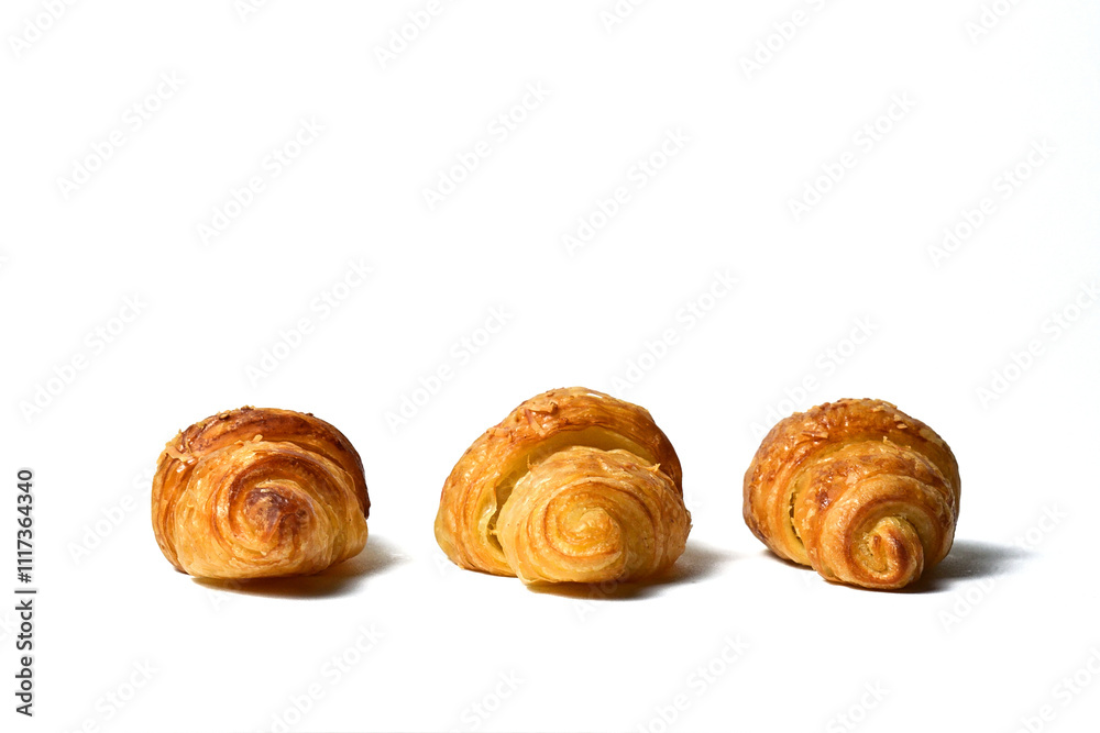 Side view of three Freshly baked mini croissants isolated on white background. Fresh croissant bread isolated. Side view of three Freshly baked mini croissants isolated on white background. Fresh croissant bread isolated.