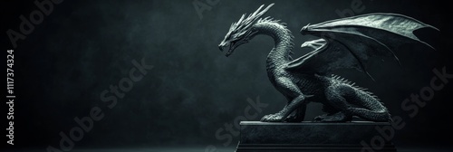 Majestic stone dragon sculpture on pedestal in dimly lit setting photo