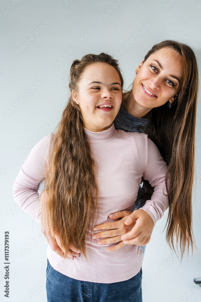 A heartwarming portrait of a mother and her teenage daughter with Down syndrome embracing affectionately. Both are smiling brightly, showcasing their close bond and unconditional love A heartwarming portrait of a mother and her teenage daughter with Down syndrome embracing affectionately. Both are smiling brightly, showcasing their close bond and unconditional love