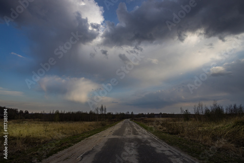 Road with a cloudy sky in the background