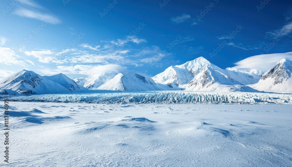 Obraz premium A stunning panoramic view of icy mountains and a glacier under a clear blue sky.