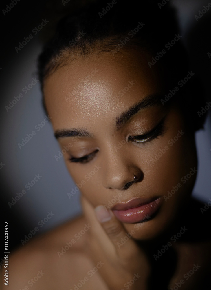 a close-up portrait of beautiful african woman against a dark background with dramatic lighting, creating a moody and artistic effect a close-up portrait of beautiful african woman against a dark background with dramatic lighting, creating a moody and artistic effect