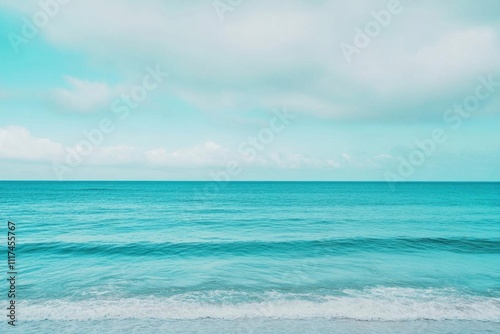 A serene ocean view with gentle waves and a tranquil sky.