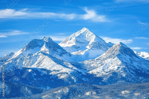 Majestic snow-capped mountains under a clear blue sky, showcasing natural beauty and serenity.