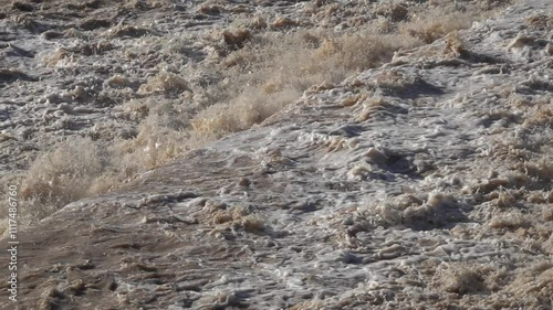  Strong flow of water and mud on a riverbed, in slow motion