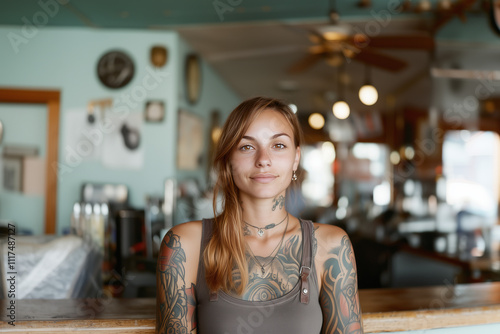 Tattoo artist with intricate designs poses in a vibrant studio filled with artistic decor and tools during daylight hours