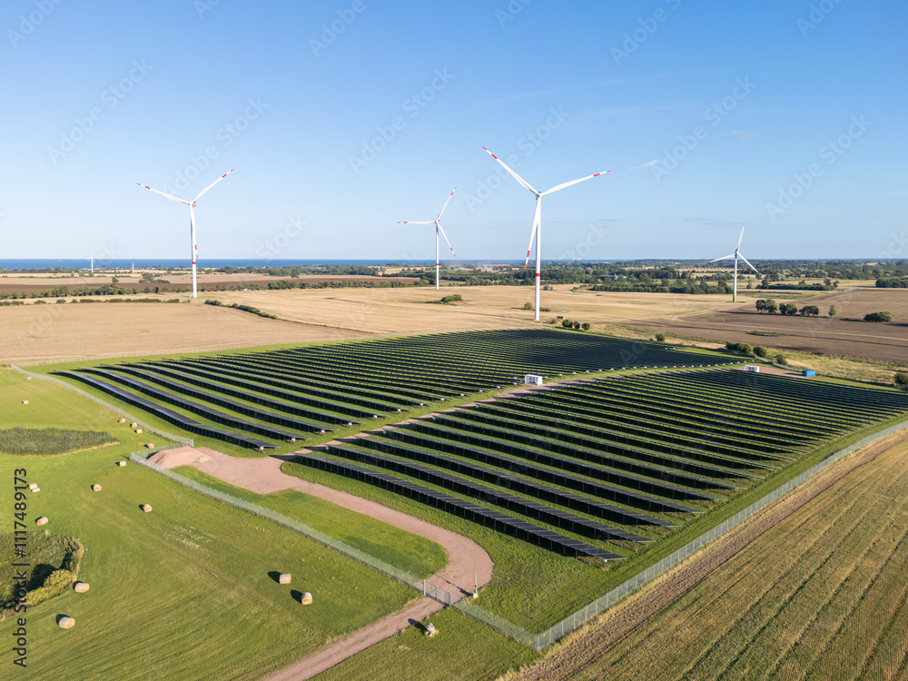 Wind and solar park turbine renewable energy power aerial view photo at the Baltic Sea near Heiligenhafen, Germany