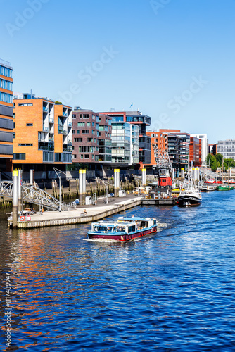 Buildings in HafenCity Sandtorhafen harbor with boats portrait format in Hamburg, Deutschland photo