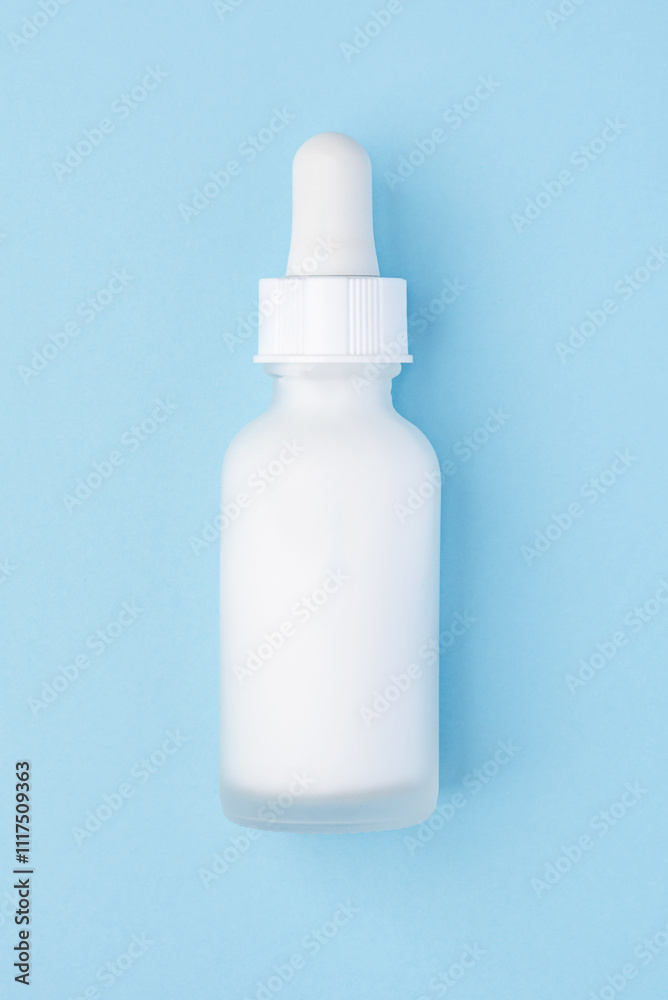 A frosted white dropper bottle with a minimalist design on a pastel blue background. Perfect for showcasing cosmetic products, branding, and packaging concepts A frosted white dropper bottle with a minimalist design on a pastel blue background. Perfect for showcasing cosmetic products, branding, and packaging concepts