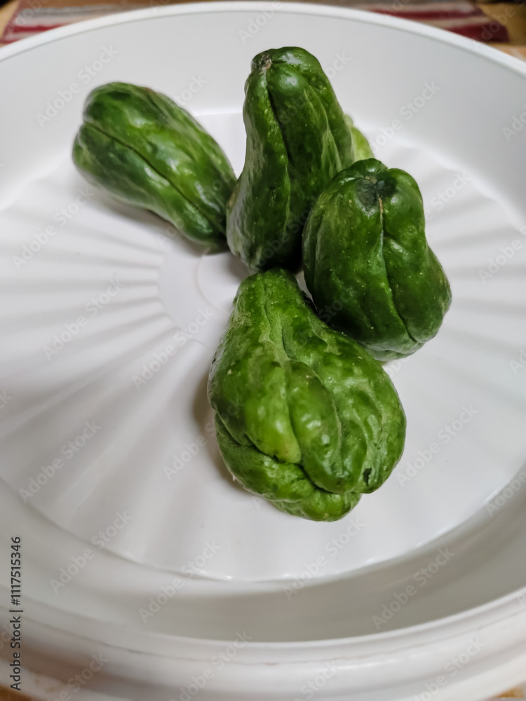 some chayote in a white plastic plate container some chayote in a white plastic plate container
