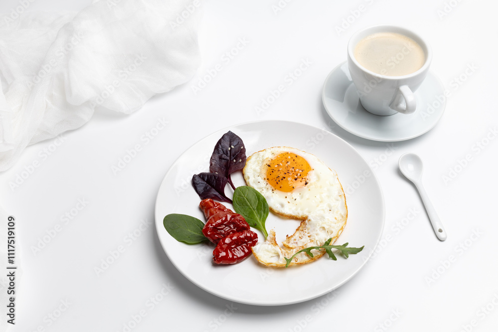 Fried egg, tomatoes and basil leaves on the plate. Fried egg, tomatoes and basil leaves on the plate.
