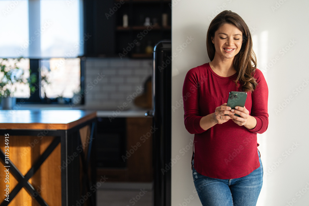 Happy relaxed young pregnant woman using cell phone, smiling lady laughing holding smartphone Happy relaxed young pregnant woman using cell phone, smiling lady laughing holding smartphone