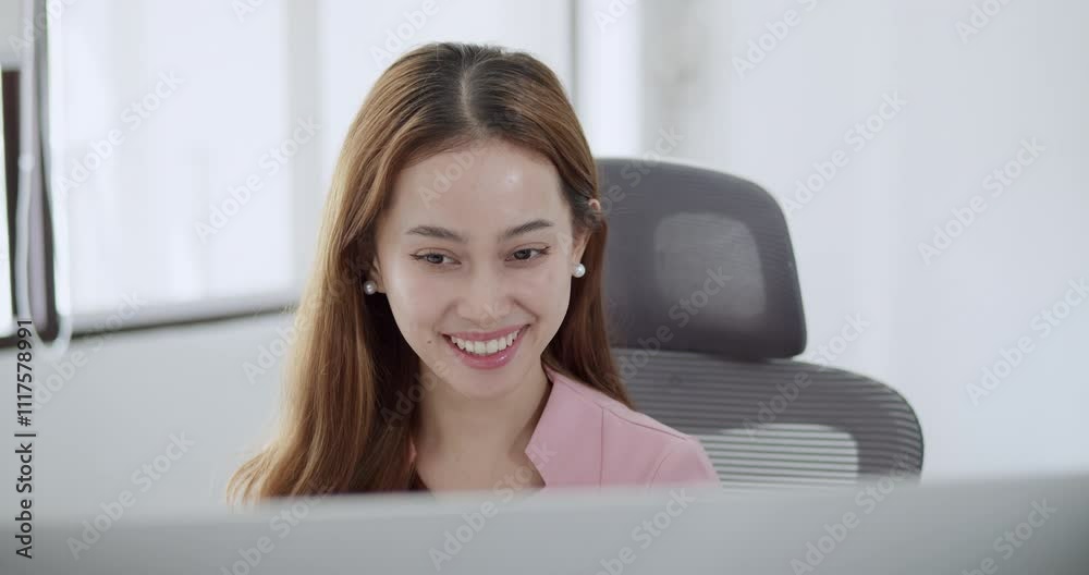 A female office worker with a positive attitude communicates confidently on her computer, ensuring success in her work tasks with a cheerful and professional demeanor. A female office worker with a positive attitude communicates confidently on her computer, ensuring success in her work tasks with a cheerful and professional demeanor.