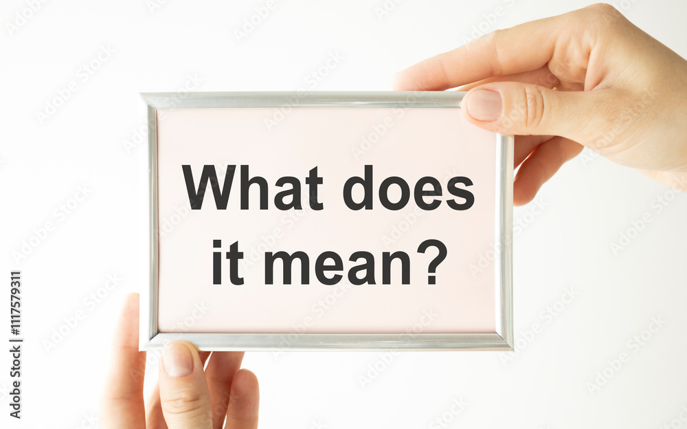 Text What Does It Means question. Concept meaning asking someone about meaning you do not understand Man holds empty paper with copy space in front of him Copy Space. Text What Does It Means question. Concept meaning asking someone about meaning you do not understand Man holds empty paper with copy space in front of him Copy Space.