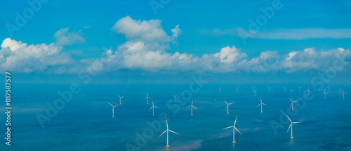 Tall windmill turbines against a clear blue sky, generating renewable energy in the serene Go Cong, Vietnam landscape by the sea. Like windmill park Westermeerdijk in the Noordoostpolder Netherlands.