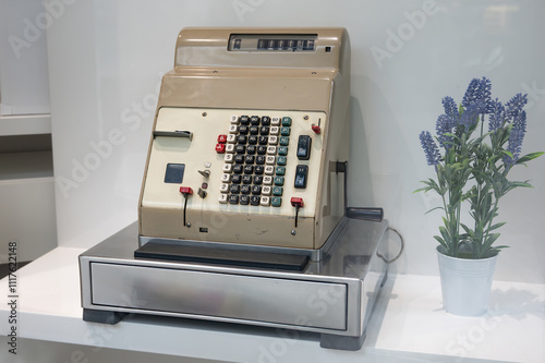 Detail of an old cash register machine displayed on the display of a store