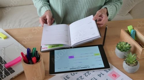 Female Entrepreneur Writing In Diary To Schedule Appointments, Meetings, And Business Plans On Desk, Perfect For Themes Of Organization, Time Management, And Professional Productivity