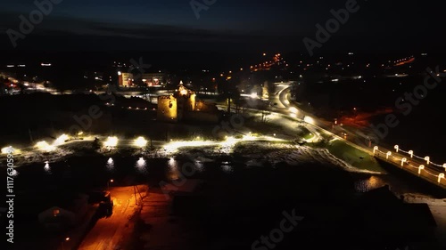 Aerial View of the Dobele City Night Landscape With Park, Livonia Order Castle Ruins in Latvia Near Berze River. Castle and Park Illuminated With Lights at Night. photo